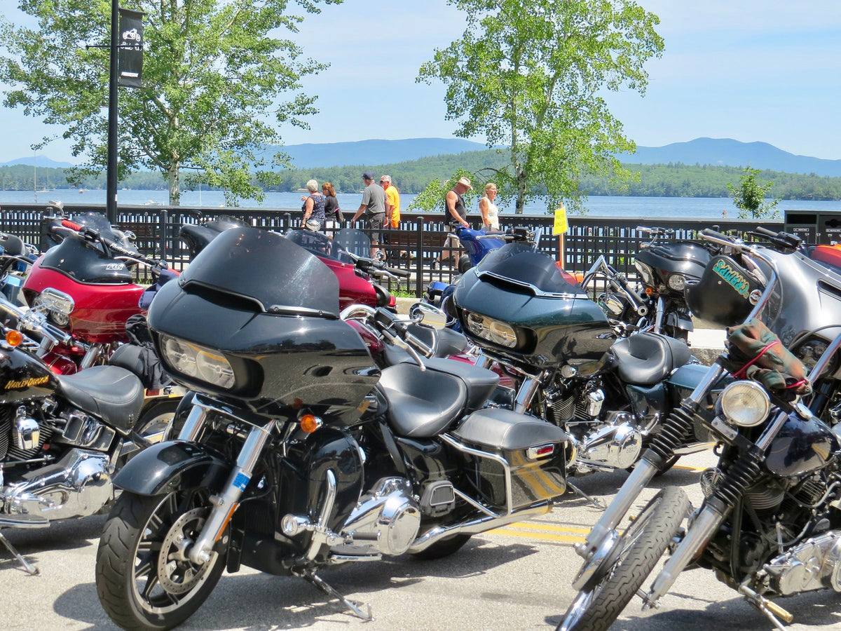 Road Glide and other baggers lined up at Laconia Motorcycle Week, Lake Winnipesaukee behind
