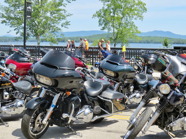 Road Glide and other baggers lined up at Laconia Motorcycle Week, Lake Winnipesaukee behind