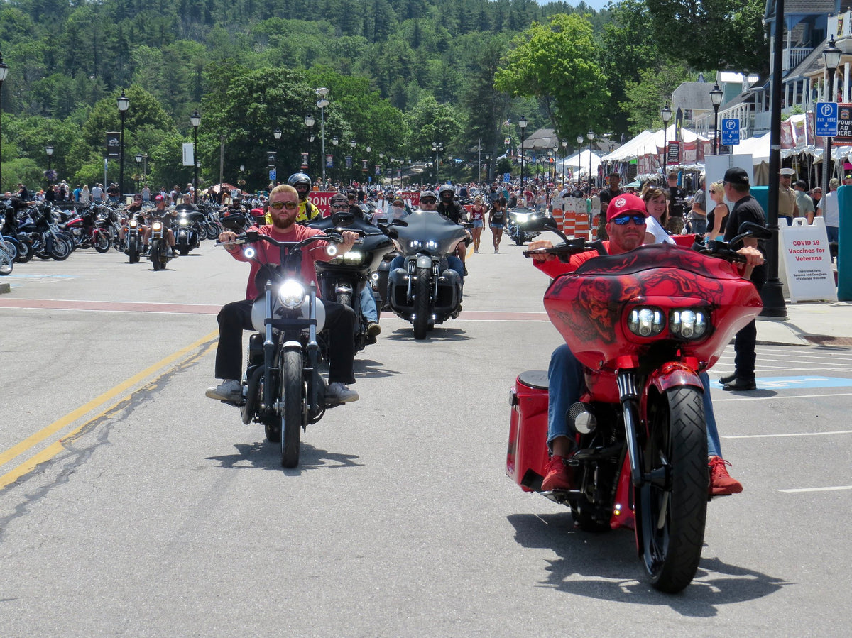 Riders on baggers incl. a red Road Glide rolling down the Weirs Beach strip, Laconia Motorcycle Week 2021