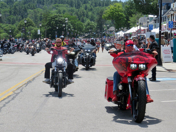 Riders on baggers incl. a red Road Glide rolling down the Weirs Beach strip, Laconia Motorcycle Week 2021