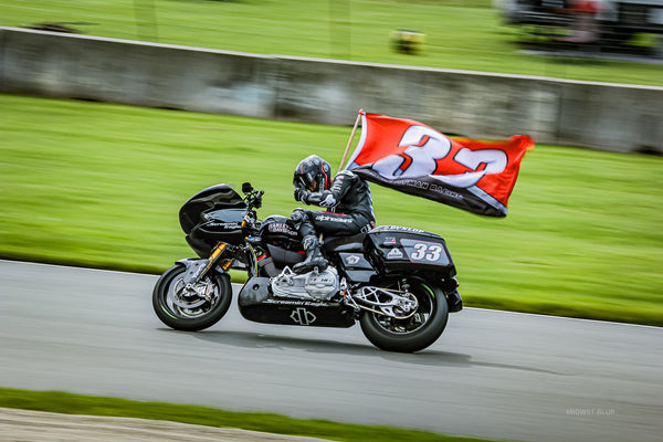 Kyle Wyman waving his number 33 flag after winning King of the Baggers at Road America, 2024