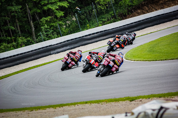 Pack of King of the Baggers race bikes through the Carousel at Road America, 2024